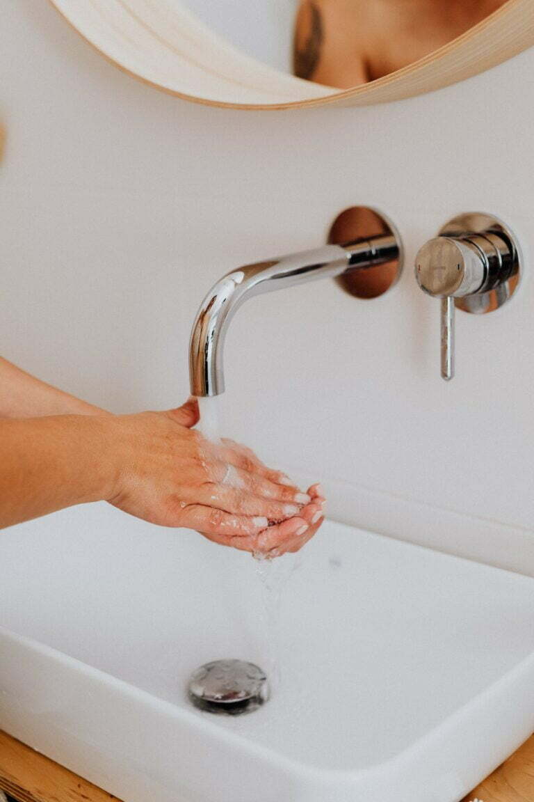 a hand holding a faucet